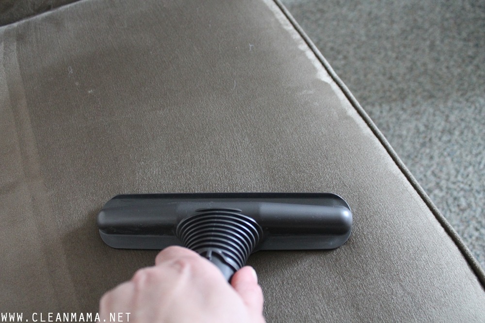 Use a vacuum cleaner upholstery attachment to clean furniture via Clean Mama
